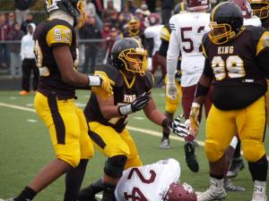 Crusaders defense celebrates a tackle for loss