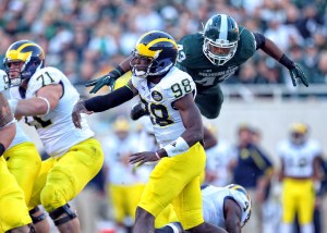 Oct 25, 2014; East Lansing, MI, USA; Michigan State Spartans linebacker Ed Davis (43) flies over block of Michigan Wolverines running back De'Veon Smith (4) during the 2nd half of a game at Spartan Stadium. MSU won 35-11. Mandatory Credit: Mike Carter-USA TODAY Sports ORG XMIT: USATSI-182278 ORIG FILE ID: 20141025_lbm_mb2_290.JPG