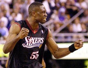 Philadelphia 76ers' Dikembe Mutombo celebrates a p